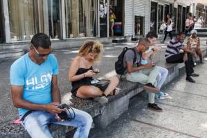 Conectados a la Wifi por pago en La Rampa. Foto: Juan Suárez